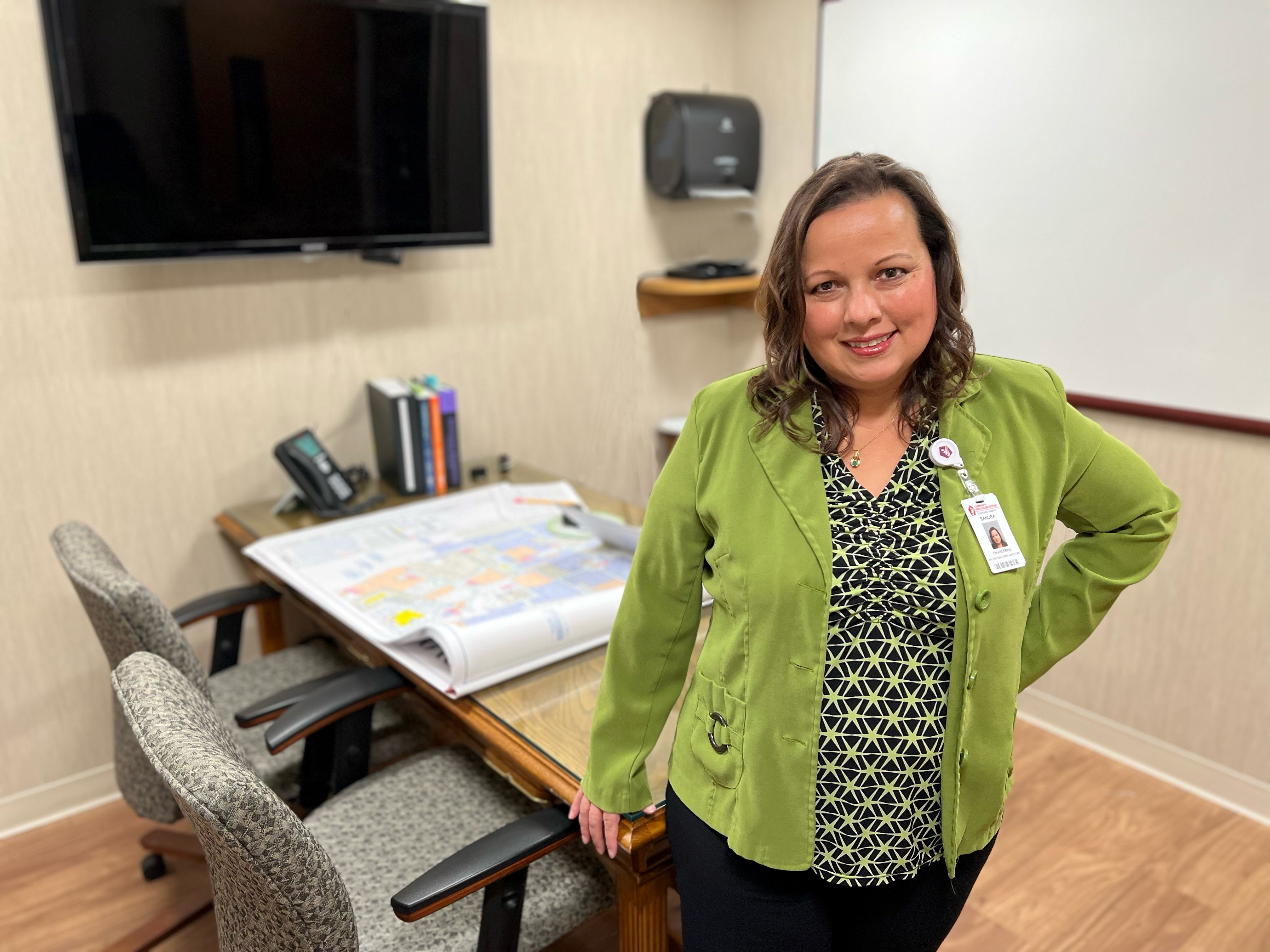 Sandy Van Prooyen standing in front of a table